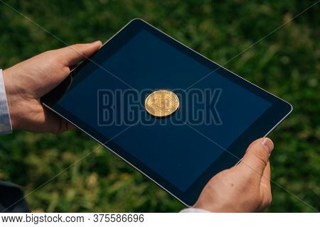 Top View Of Bitcon Cryptocurrency Lies On Digital Tablet. Virtual Money Or Coin Close Up Sign