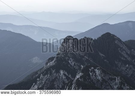 Spectacular View Of Grey Mountain Ranges Silhouettes And Fog In Valleys. Julian Alps, Triglav Nation