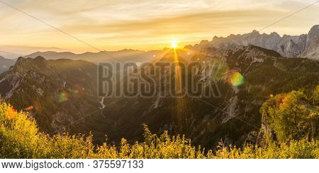 Amazing Sunrise In The Mountains. Backlight Sunlight With Beautiful Lens Flares And Sunbeams. Panora