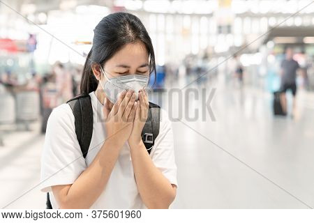 Asian Woman Feeling Sick, Coughing Waering Healthy Face Mark Protect Corona Virus With Airport Termi