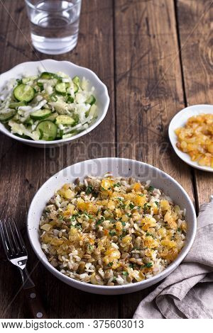 Traditional Middle Eastern Dish, Mujadara Of Lentils, Rice And Fried Onions With A Salad Of Cabbage 
