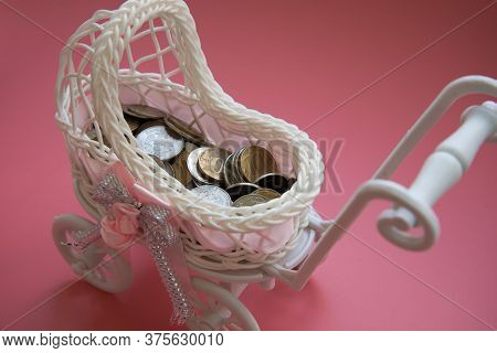 There Are Coins In The Pram. Close Up. Concept Of State Support. Concept Of Child Trafficking. Surro