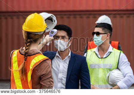 Engineer Worker Wearing Surgical Mask Checking Body Temperature Using Infrared Digital Thermometer C