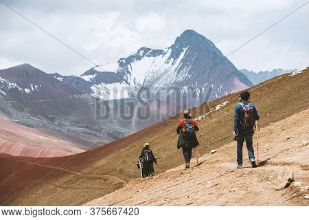 Vinicunca, Peru - October 29: Three Tourists Hiking By Altitude Mountain Trail Near Vinicunca Area, 