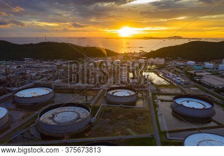 Aerial View Of Oil Refinery Plant Chemical Factory And Power Plant With Many Storage Tanks And Pipel