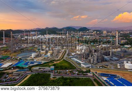 Aerial View Of Oil Refinery Plant Chemical Factory And Power Plant With Many Storage Tanks And Pipel