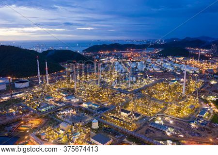 Aerial View Of Oil Refinery Plant Chemical Factory And Power Plant With Many Storage Tanks And Pipel