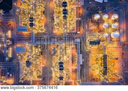 Aerial View Of Oil Refinery Plant Chemical Factory And Power Plant With Many Storage Tanks And Pipel