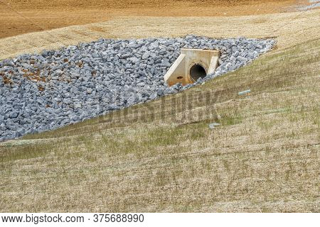 Horizontal Shot Of A Culvert And Drainage Ditch Under Construction.  

Drainage Ditch Pipe In Backgr
