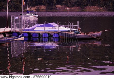 Roznow, Poland - September 04, 2014: A Man Fishing On An Anchored Boat In Roznowskie Lake