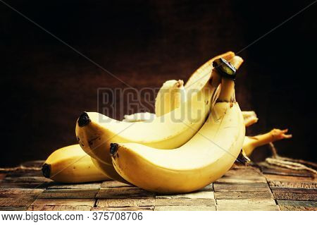 Ripe Bananas On A Vintage Wooden Background, Rustic Style, Selective Focus