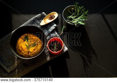 Vegetable Menu With Batat And Carrots On A Dark Surface With A Gray Terry Towel. Fresh Rosemary And 