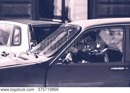 Driving Old Dacia 1300 Close Up Isolated. Couple In Dacia 1300 Romanian Vintage Car On The Streets O