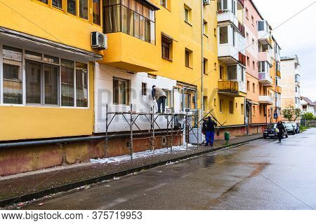 Workers Isolating Apartment With Polystyrene, Thermal Isolation Of Facade Of House In Lugoj, Romania