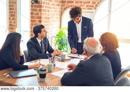 Group of business workers working together in a meeting. Listening one of them speaking at the office.