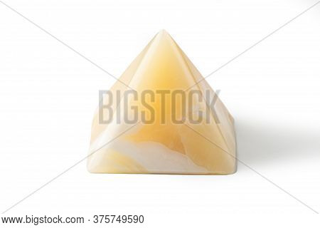 Pyramid Made From Yellow Onyx Possesses Mystical Properties. Souvenir Semiprecious Stone On A White 