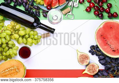 A Bottle Of Wine, Wineglass, Grapes, Different Fruits And The Flag Of Italy. Country Symbol Backdrop