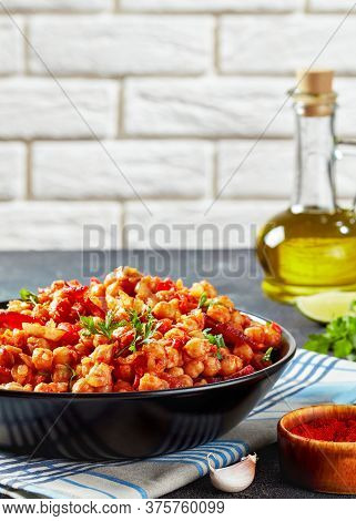Garbanzos Fritos, Hot Chickpea Stew With Chorizo, Tomatoes And Spices In A Black Bowl On A Concrete 