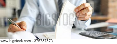 Close-up Of Accountant Specialist Sitting In Modern Office With Calculator And Paper Checks. Man In 