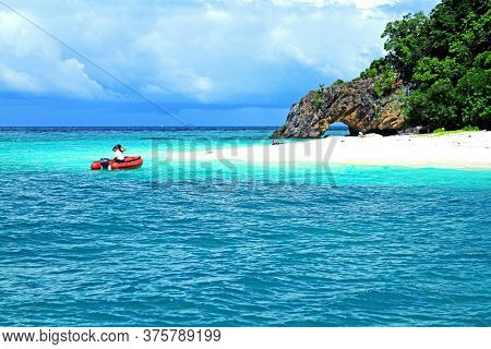 Tourist Taking A Red Boat To The Island On Andaman Sea, Krabi, Thailand. Beautiful Deep Sea And Whit