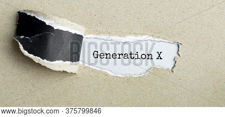 The Text Generation X Appearing Behind Torn Brown Paper
