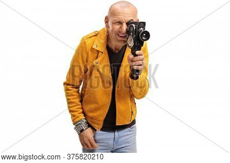 Bald hipster guy filming with a vitnage camera recorder isolated on white background