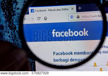 Facebook Website Home Page On Computer Screen On Magnifying Glass. Facebook Web Browser Developed By