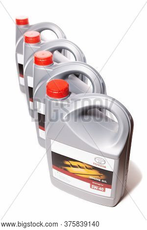 Kharkiv, Ukraine - December 6, 2019: Vertical Row Of Plastic Cans With Motor Synthetic Oil Toyota 5w