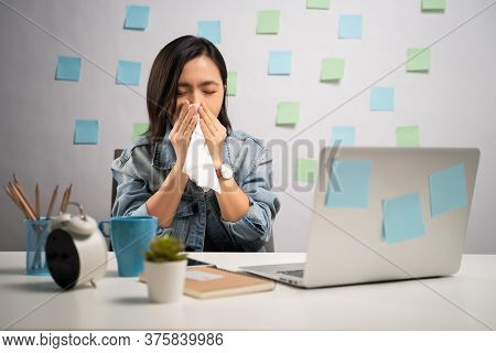 Asian Woman Working On A Laptop Was Sick With Fever Sitting At Home Office. Wfh. Work From Home. Pre
