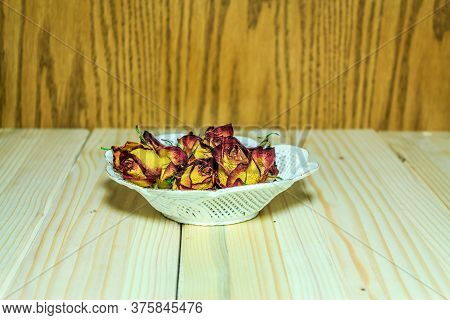 Shot To A Plate Full Of Artifficial Ornamental  Roses