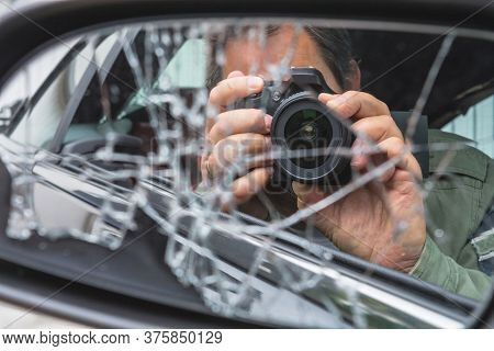 Reflection In Side Mirror Paparazzimannes Sitting Inside The Car And Photographing With Slr Camera.
