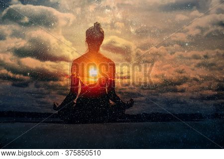 Yoga Day Concept. Multiple Exposure Image. Clouds And Sun. Pranayama In Lotus Asana.