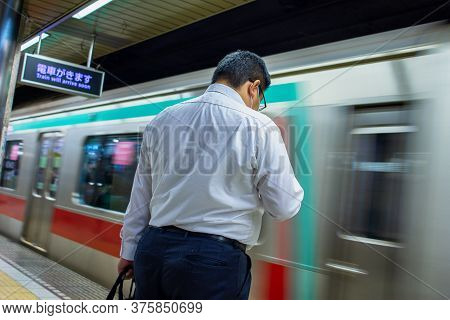 Tokyo / Japan - October 19, 2017: Businessman Waiting For A Subway Of Tokyo Metro In Tokyo Japan
