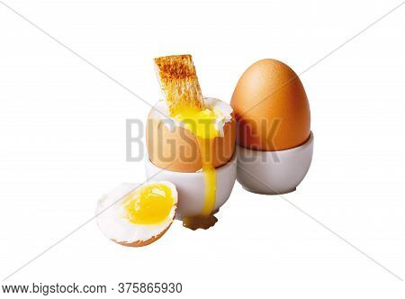 Soft-boiled Eggs In White Eggcups With Rye Crouton Isolated On White Background. Egg With Crumbs For
