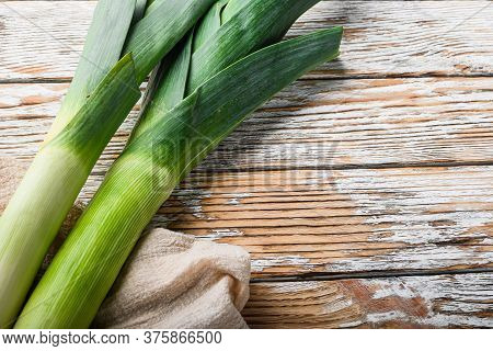 Organic Leek Onion On White Wooden Background, Side View.