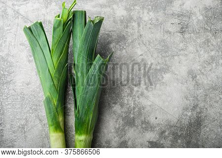 Organic Leek Onion On Grey Textured Background, Top View With Space For Text.