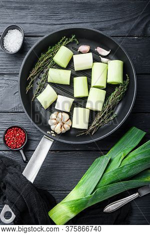 Green Leeks Sultan  Chopped Oninon On Grill Pan Uncooked With Herbs Ingredients , On Textured Black