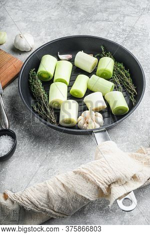 Raw Braised Leek Sultan On Grill Pan Uncooked With Herbs Ingredients  , On  Grey Textured Background