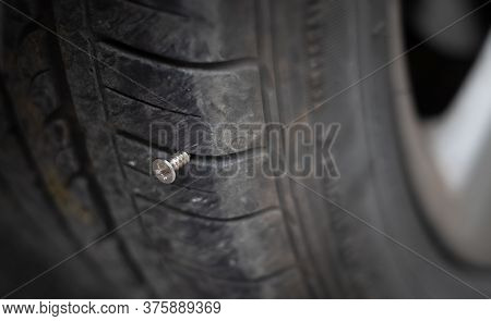 Close Up Button Head Needle Metal Screw Nail Stuck To Puncture Into Wheel Tire