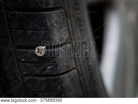 Close Up Button Head Needle Metal Screw Nail Stuck To Puncture Into Wheel Tire