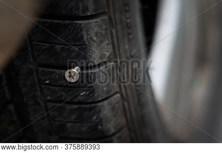 Close Up Button Head Needle Metal Screw Nail Stuck To Puncture Into Wheel Tire
