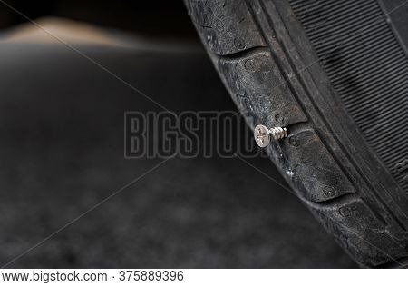 Close Up Button Head Needle Metal Screw Nail Stuck To Puncture Into Wheel Tire