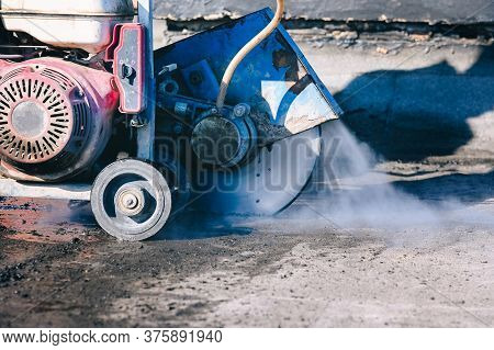 Roof Cutter Machine During Working Process, Closeup. Roof Repait And Rennovation Concept.