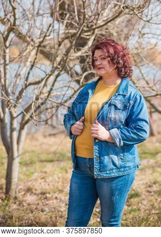 Mature Plus Size Woman, American Or European Appearance Walks And The  Enjoying Life. Lady With Exce