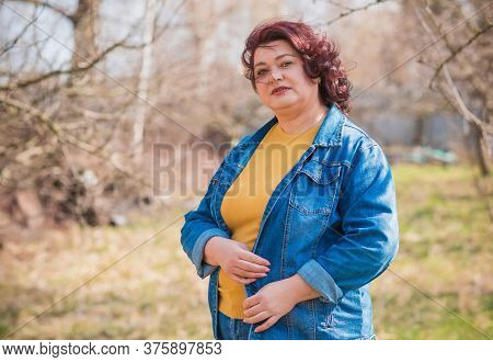 Mature Plus Size Woman, American Or European Appearance Walks And The  Enjoying Life. Lady With Exce