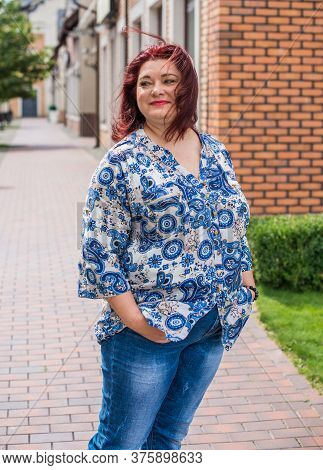 Mature Plus Size Woman, American Or European Appearance Walks And The  Enjoying Life. Lady With Exce