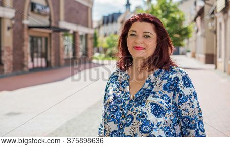 Mature Plus Size Woman, American Or European Appearance Walks And The  Enjoying Life. Lady With Exce