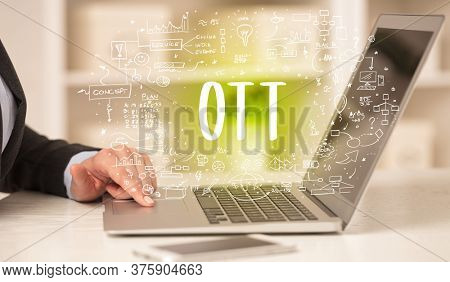 hand working on new modern computer with OTT abbreviation, modern technology concept