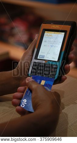 Salvador, Bahia / Brazil - November 22, 2019: Person Uses Credit Card Machine In Shoppng Shop In The