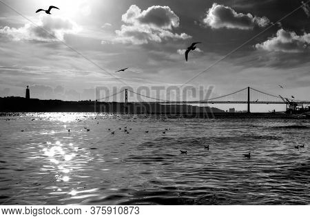 The 25th Of April Bridge (ponte 25 De Abril) Across The Tagus (tejo) River, Lisbon, Portugal. Artist